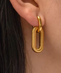 a woman wearing Rippled Gold Drop Earrings