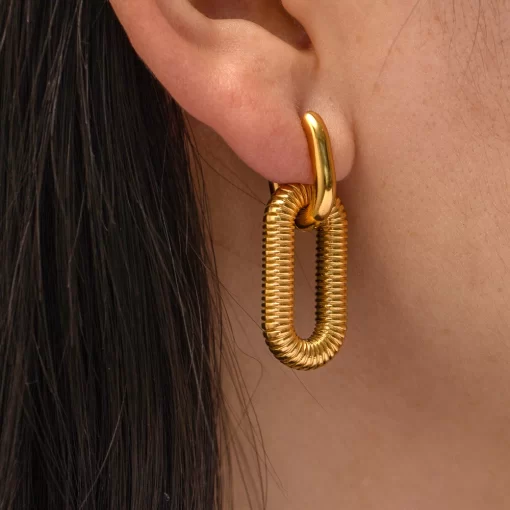 a woman wearing Rippled Gold Drop Earrings