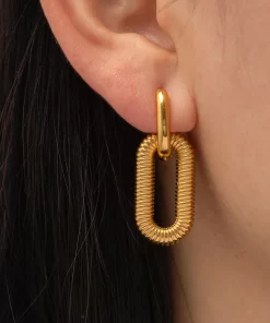 a woman wearing Rippled Gold Drop Earrings