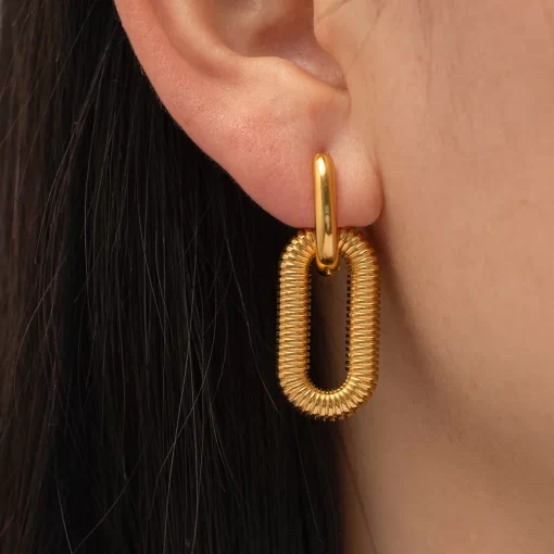 a woman wearing Rippled Gold Drop Earrings