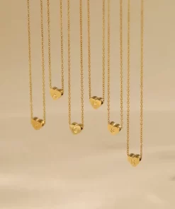 a few Gold heart initial necklace dangling