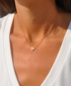 a woman wearing Gold heart initial necklace