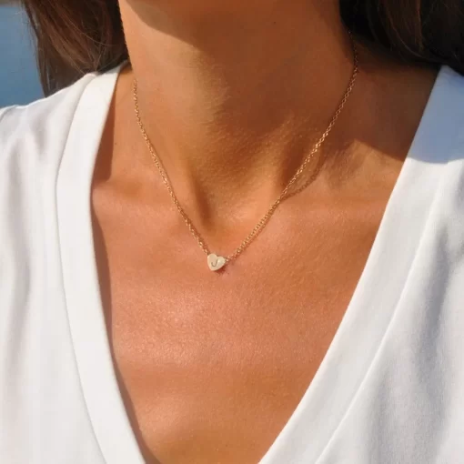 a woman wearing Gold heart initial necklace